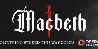 The word “Macbeth” in gothic font with a red sword as the “t,” smoky background, “Something wicked this way comes,” and the Opera Colorado logo in the lower right corner.
